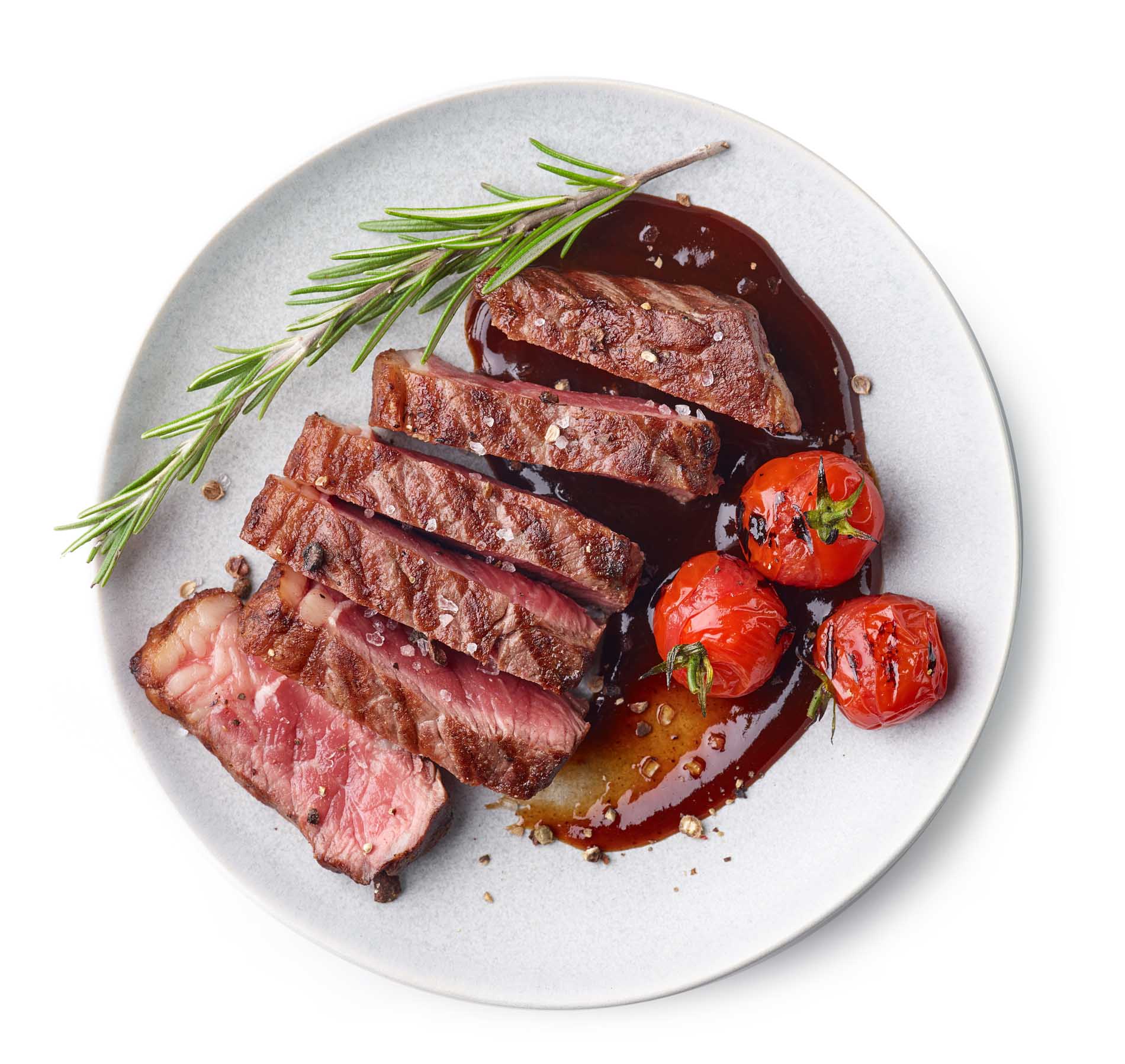 Grilled,Sliced,Beef,Steak,With,Tomatoes,And,Rosemary,On,A